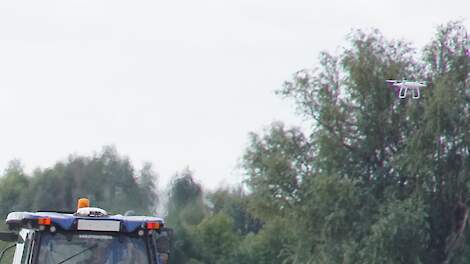 Drone en trekker tegelijk in het veld