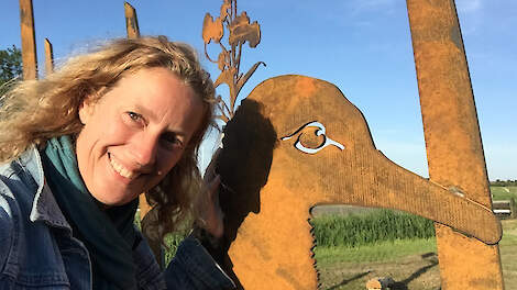 Barbe Messing legt beleefpaden aan. Hier staat ze bij een grote stalen weidevogel op Terschelling, een van haar creaties.