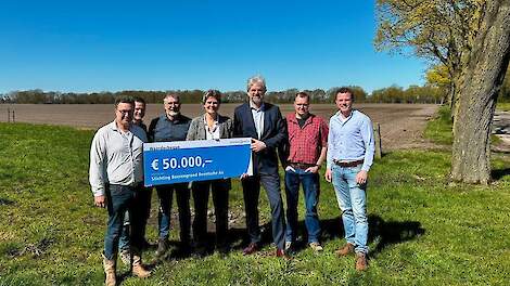 Gedeputeerden Willemien Meeuwissen en Henk Emmens overhandigen de cheque van 50.000 euro aan de stichting Boerengrond Drentsche Aa.